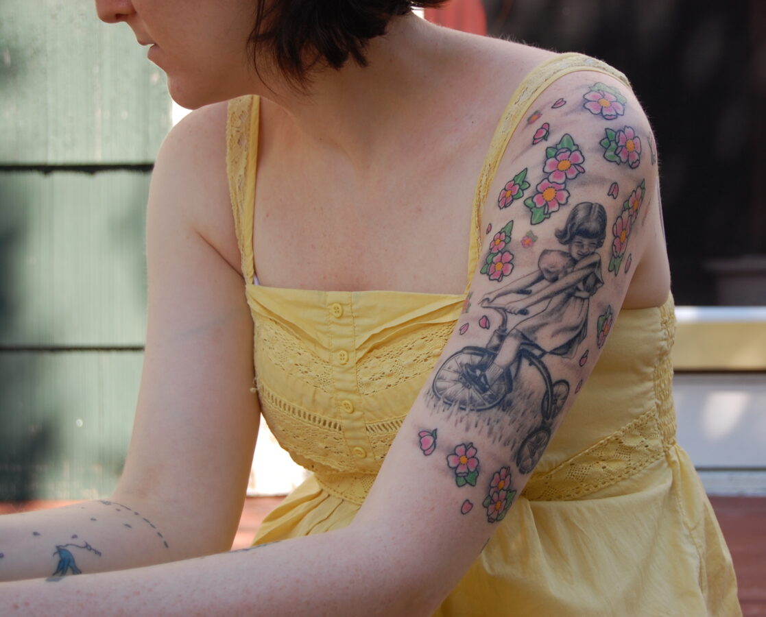 mom on tricycle finished arm tattoo