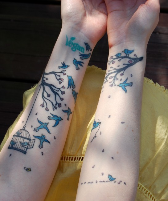 vegan birds flying out of cage forearm tattoos